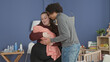 © Krakenimages.com - Plus size woman cradles swaddled baby in nursery as man leans in to support and kiss the forehead by crib and changing table; parental love together.