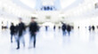 © Rahman - Blurred view of people walking in a modern bright white architectural interior space