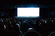 © Nikolay N. Antonov - Full audience seated in a dark movie theater watching a blank white cinema screen, ideal as a mockup template for film premieres or presentations