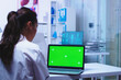 © DC Studio - Health practitioner using laptop with chroma key in a hospital cabinet, connecting clinical notes, diagnosis work and editable laptop display space in a practical clinical setting.