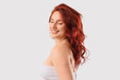 © Pixel-Shot - Smiling young woman with long wavy red hair and closed eyes, natural beauty and self-care concept, isolated on a white background