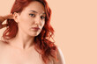 © Pixel-Shot - Young woman with red hair listening intently with hand cupped to ear, hearing and communication