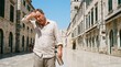 © Asril - Man struggles with intense summer heat, wiping sweat from his brow on a scorching day while exploring ancient city streets, seeking hydration
