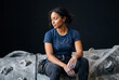 © Meow Creations - Young female rock climber covered in white chalk resting thoughtfully on an indoor climbing wall