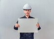 © Pornprasit Panada - Asian male engineer holding large blank horizontal poster board. Concept for industrial construction announcement, project presentation mockup. High-quality studio shot.