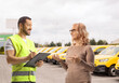 © Ljupco Smokovski - Woman talking to a road help worker on a parking lot