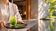 © SoloPixel - Spa attendant carrying iced matcha beside tranquil pool