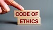 © romio - Code of ethics concept with wooden blocks and business compliance governance principles