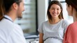 © Mary - Smiling pregnant woman consulting with medical professionals in office
