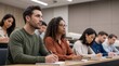 © Eve - Group of diverse adult students in university lecture hall writing notes, professional development course, corporate education training, multiethnic college classroom, learning concept