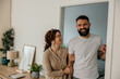 © La Famiglia - Happy couple standing in doorway smiling