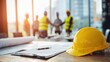 © Maryna - Yellow hard hat on a desk with contract documents signaling a construction project partnership
