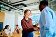 © we.bond.creations - Business partners forming an agreement and connection shaking hands, smiling in a modern office meeting space