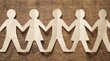 © Creative Stock Lab - Paper chain of people holding hands on wooden background