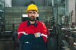 © chokniti - Worker helmet factory uniform man industry, machinery, safety, engineer, workshop portrait of serious adult male worker wearing yellow helmet and red uniform in industrial factory