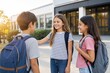© Olena Apetroaiei - Students gather outside a school to celebrate the start of a new school year while carrying backpacks with supplies