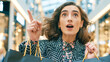 © Ali Hassan - A young woman with curly hair and a patterned coat looks surprised and points upward while holding shopping bags in a blurred, brightly lit, modern shopping mall interior setting.