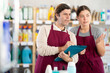 © JackF - Two sellers makes notes on an paper - conducts an inventory in supermarket
