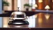 © Kathleen - shiny silver service bell placed on polished hotel reception desk elegant professional hospitality