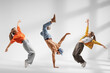 © Ljupco Smokovski - Guy performing handstand and two girls dancing