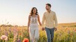© Rendara Studio - Happy couple holding hands walking through blooming wildflower field at sunset