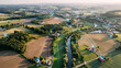 © Shahriar - Aerial view of a rural landscape with digital network connections overlaying villages and farms representing global connectivity and infrastructure