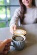 © Farknot Architect - Vertical closeup image of couple people clinking coffee cups in cafe