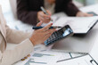 © mojo_cp - Corporate analyst sitting at desk with audit papers, financial ledger and calculator in business environment