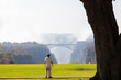 © Marc Romanelli - young boy walking past view of Victoria Falls and Victoria Falls Bridge from the Zimbabwe side, Zimbabwe, Africa