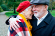© pressmaster - Senior Caucasian couple embracing and smiling during park walk, expressing affection, companionship, active retirement. Close up, ideal for senior lifestyle, insurance, wellness marketing