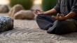 © Thares2020 - A person meditating peacefully in a serene Japanese style garden featuring meticulously raked sand and smooth stones