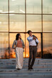© Zoran Jesic - Business professionals communicating on steps at sunset