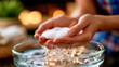 © Aliaksandra - Hands rinsing a reusable cotton pad in a glass bowl, eco-friendly skincare, cleansing routine, hygiene and sustainable beauty concept