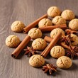 © Sayfar - Small, crunchy spiced cookies known as kruidnoten scattered on a rustic wooden surface with cinnamon sticks and star anise winter spices, flat lay, crispy, nutmeg