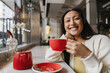 © Angel Santana/Stocksy - Asian Woman ethnicity enjoying tea time at a cafe