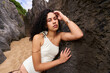© Alvaro Lavin/Stocksy - Woman posing on a rocky beach wearing swimwear