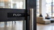 © Mahmuda - Modern office glass door handle | Commercial building entrance with push sign | Stainless steel door hardware for business | Minimalist office interior design entrance