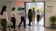 © Jafree - Group of office workers walking through emergency exit during fire drill. People evacuating modern building carefully. Safety training procedure at workplace for collective security