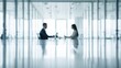 © Generative AI - Two business professionals in a modern, bright office, discussing strategy across a long, reflective conference table