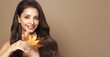© Oleg Gekman - Portrait of beautiful young woman with autumn leafs. Healthy clean fresh skin natural make up.Long curly hairstyle. Care and beauty hair products
