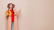 © Oleg Gekman - A beautiful young woman in an autumn fashionable outfit with shopping bags and round hat pointing aside at free space over beige background