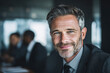 © Mahadina - Cheerful businessman with smiling face in meeting room
