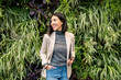 © Westend61 - Confident businesswoman in casual outfit holding laptop outdoors