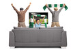 © Ljupco Smokovski - Happy kid and elderly men watching football and cheering in front of tv