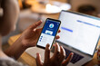 © Marko Geber - Person using smartphone banking app at home office