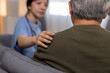 © Ratirat - Caring female nurse providing comfort to senior man patient showing empathy and compassion during medical consultation offering emotional support for health condition