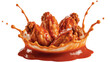 © JOHIRUL - Spicy buffalo chicken wings splashing in hot red sauce isolated on transparent background.