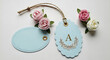 © KHAYRUN - Two pastel blue gift tags with floral embellishments and twine lying on a white surface
