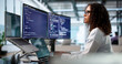 © Andrey Popov - Young African Woman Engineer Coding On Laptop And Desktop