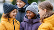 © Nataliya - Diverse children in warm winter jackets chatting outdoors in a park during the cold season, friendly outdoor conversation , with copy space